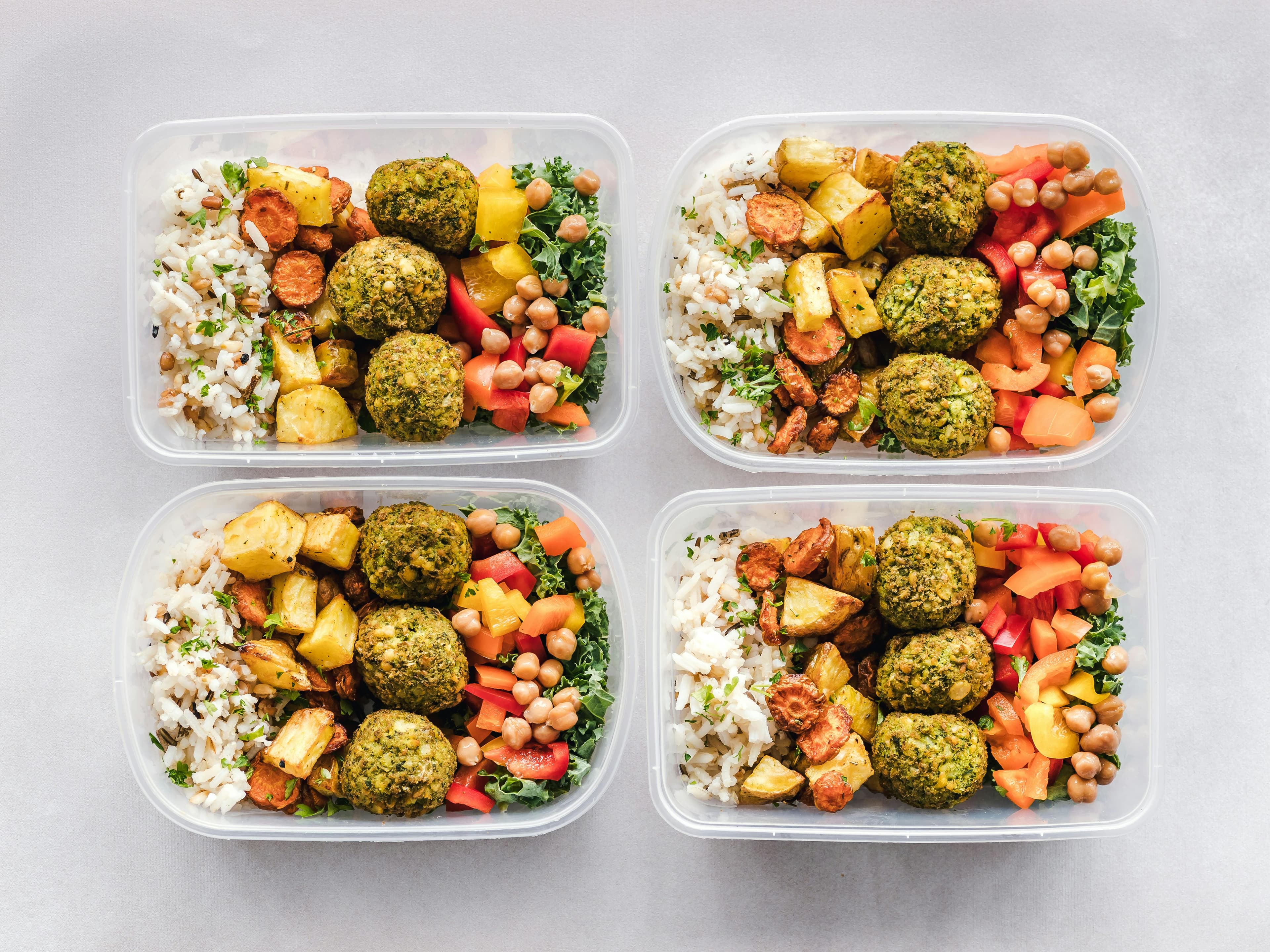 Healthy meal prep containers with lean proteins, vegetables, and whole grains arranged for GLP-1 diet success