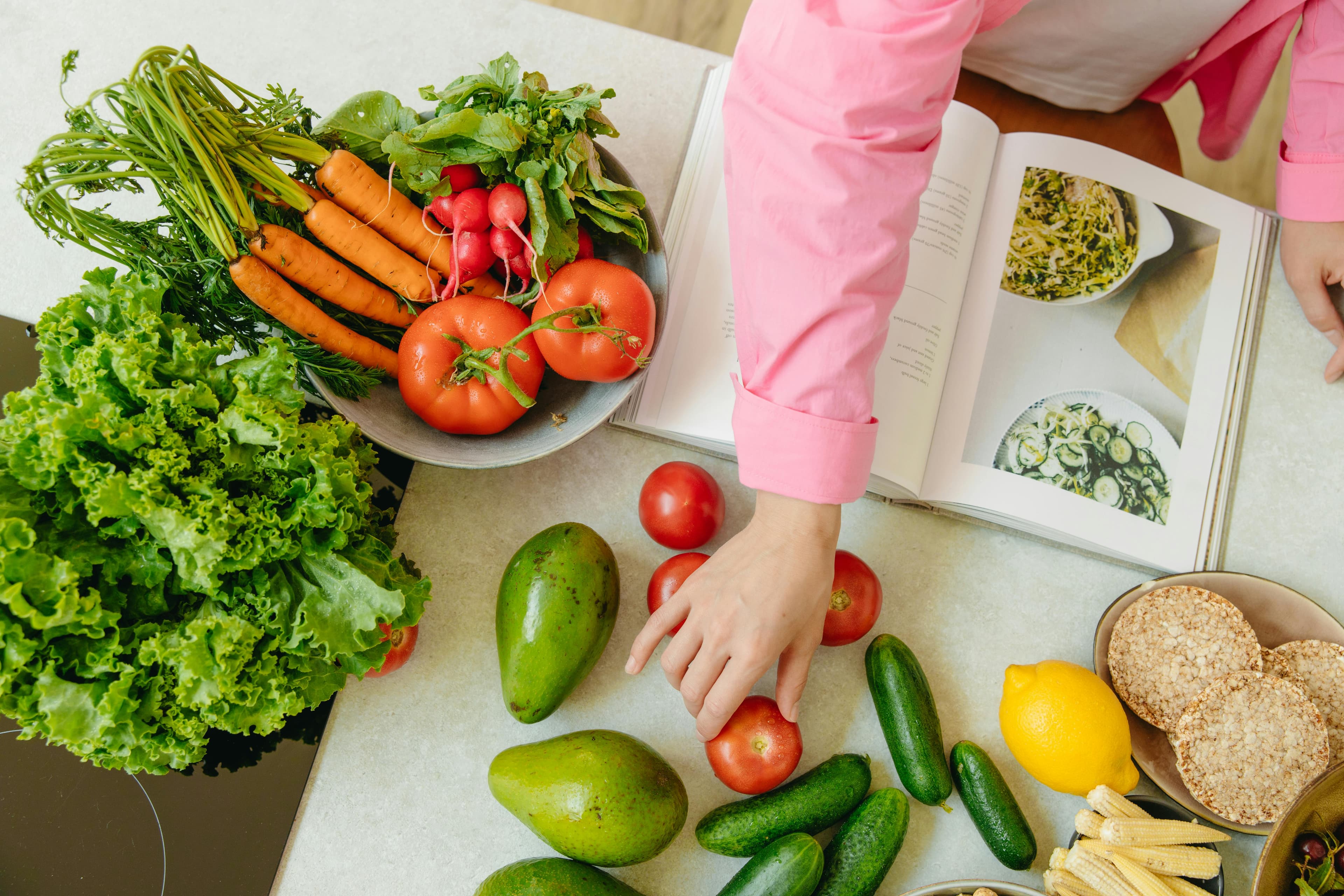 Woman using smartphone to track calories with AI app while enjoying a healthy, balanced meal